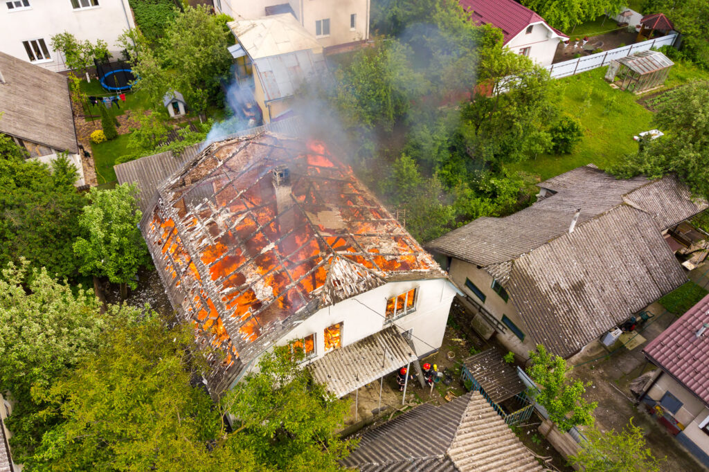 Aerial View Of A House On Fire With Orange Flames Utc