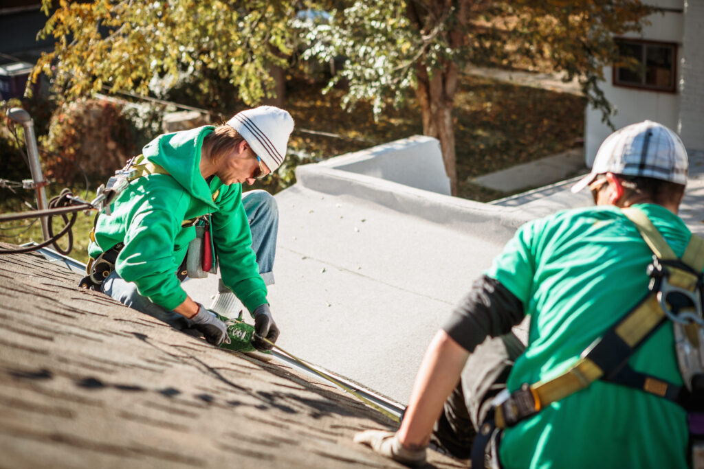 Solar Panel Installation Crew Members On Roof Of H Utc