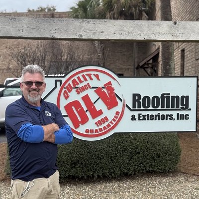Vern McQueen, A man is standing in front of a sign that says “Roofing & Exteriors, Inc” with a logo that reads “QUALITY SINCE BLV 1999” and he has his arms crossed Vern McQueen, A man is standing in front of a sign that says "Roofing & Exteriors, Inc" with a logo that reads "QUALITY SINCE BLV 1999" and he has his arms crossed