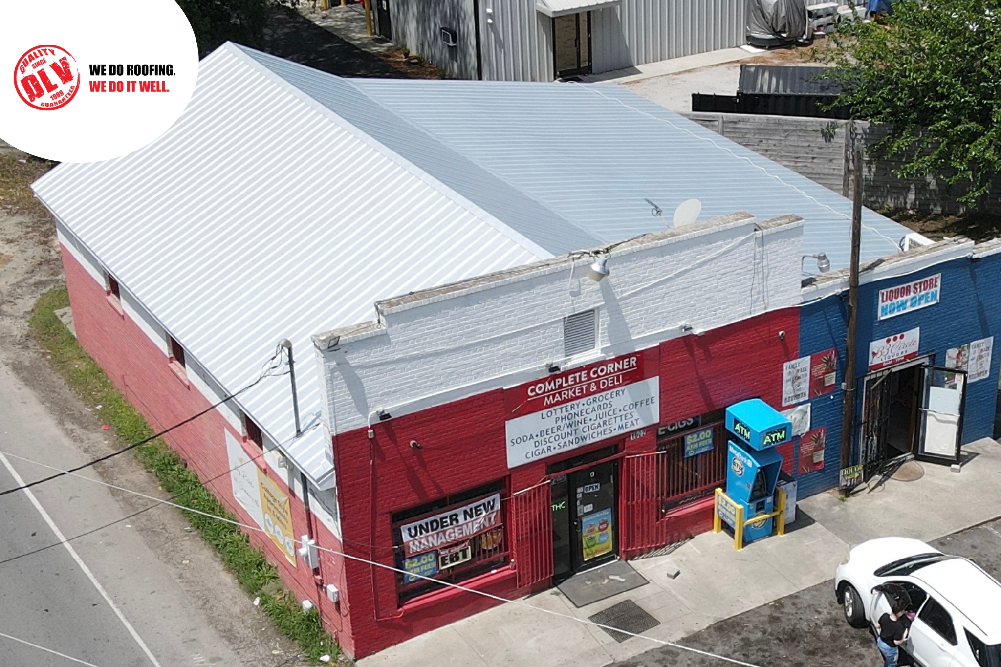 The building below is painted red, white, and blue, housing a convenience store and liquor store.